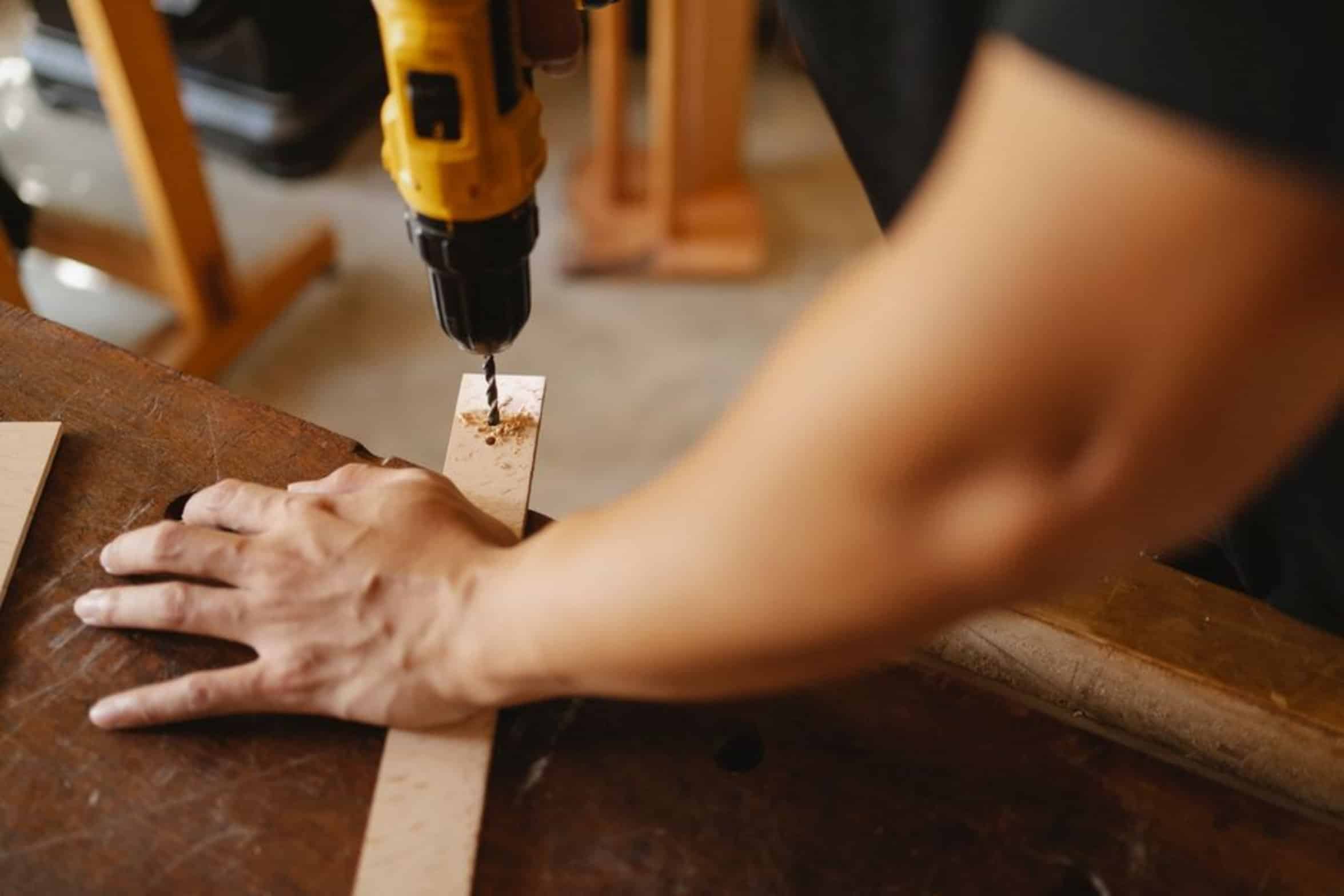 hand holding cordless drill hand holding cordless drill